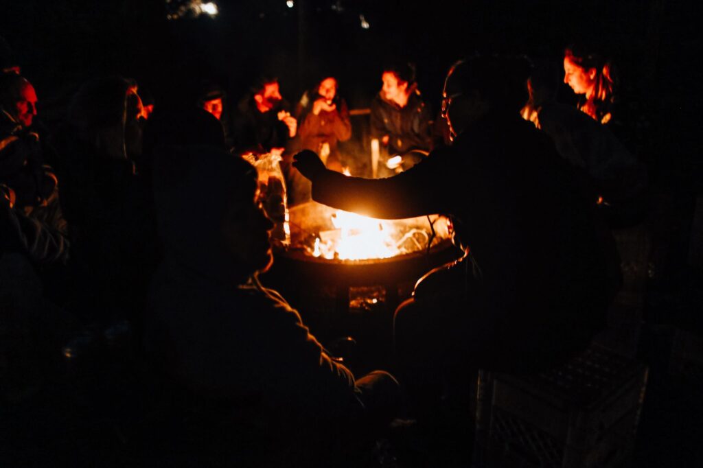 A fire pit burning after dark